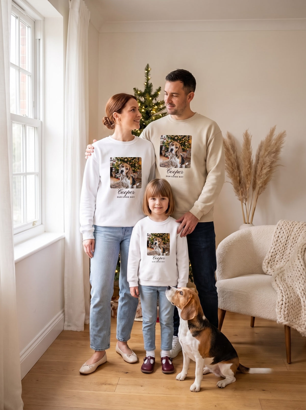 Family in matching custom pet photo sweatshirts with their beagle
