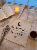 Cozy evening flat lay of the Reading Under the Moon tote on a knit blanket by the window