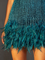 Close-up of the teal After Midnight dress: sequin strand fringe and feather trim hem