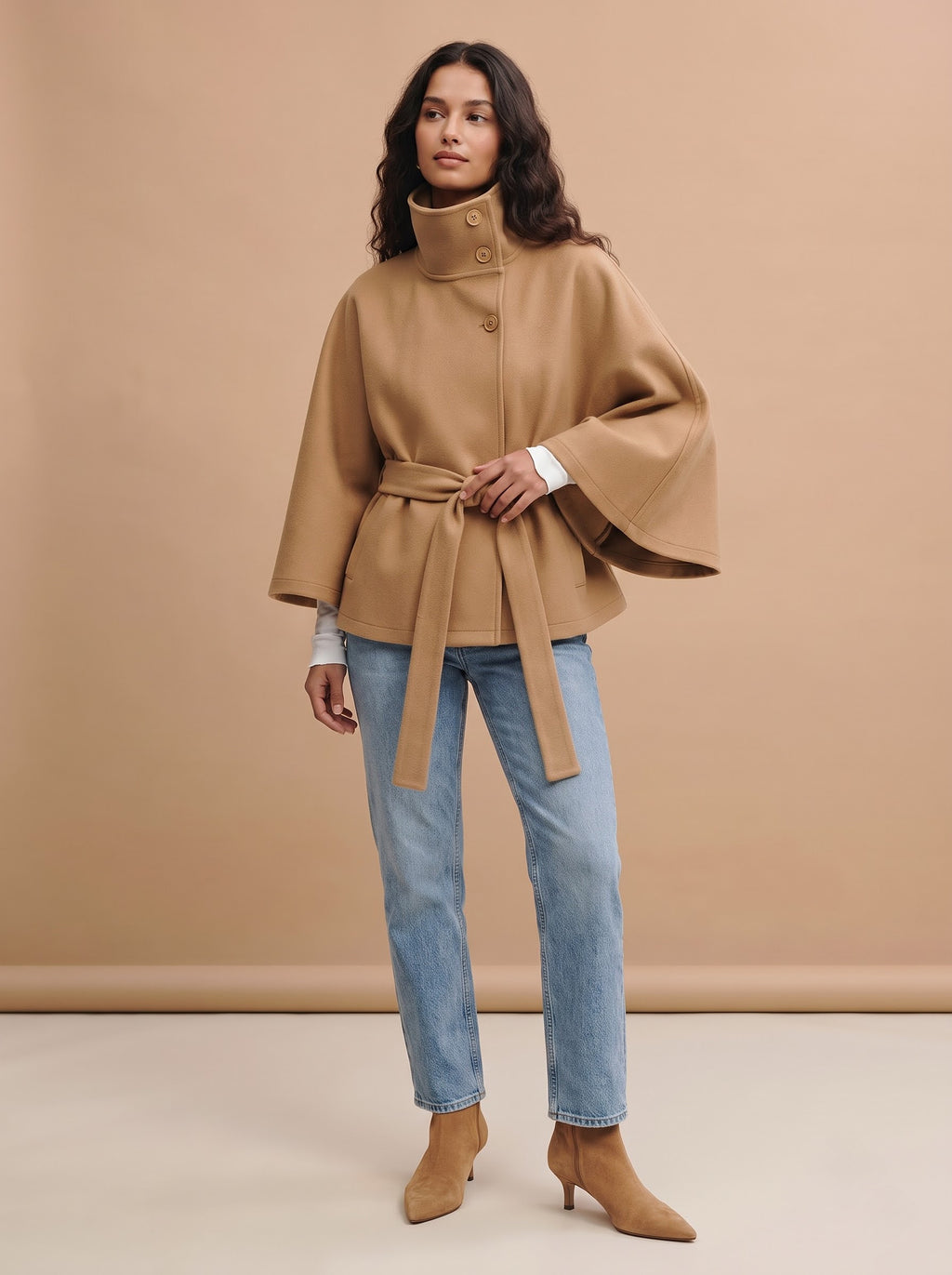 City Muse belted cape trench coat in camel, full-length studio view with jeans and suede ankle boots