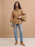 City Muse belted cape trench coat in camel, full-length studio view with jeans and suede ankle boots