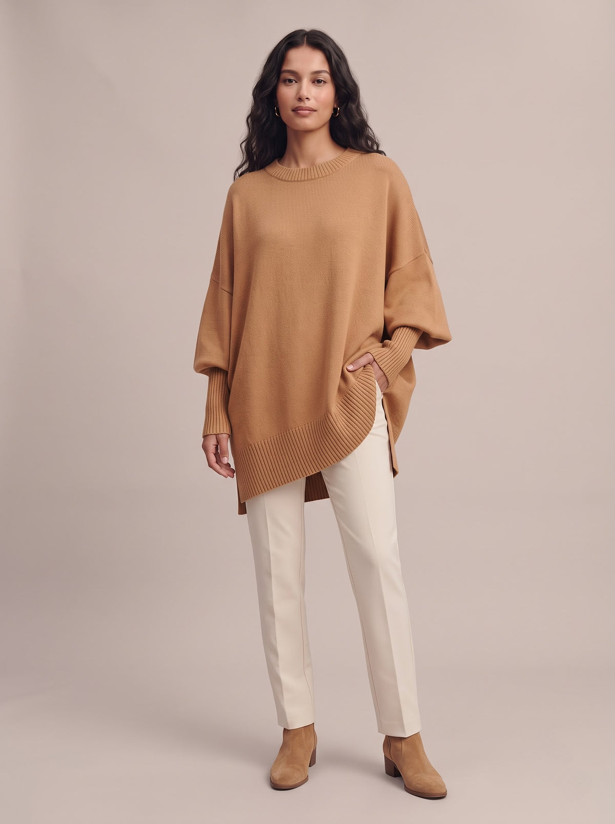 Easy Sunday oversized batwing crew neck sweater in camel, worn with slim cream trousers and suede ankle boots, studio photo