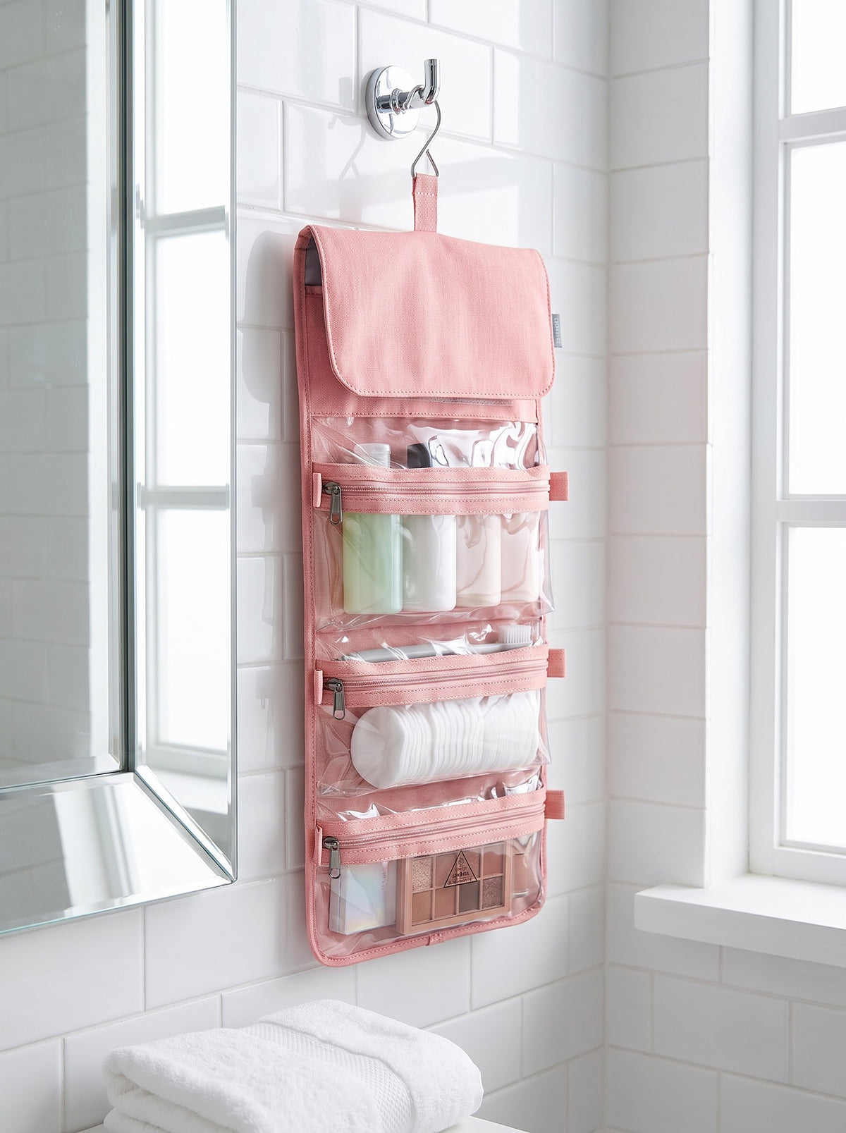 Hanging pink toiletry pouch with clear zip compartments, included with the Bag + toiletry pouch option
