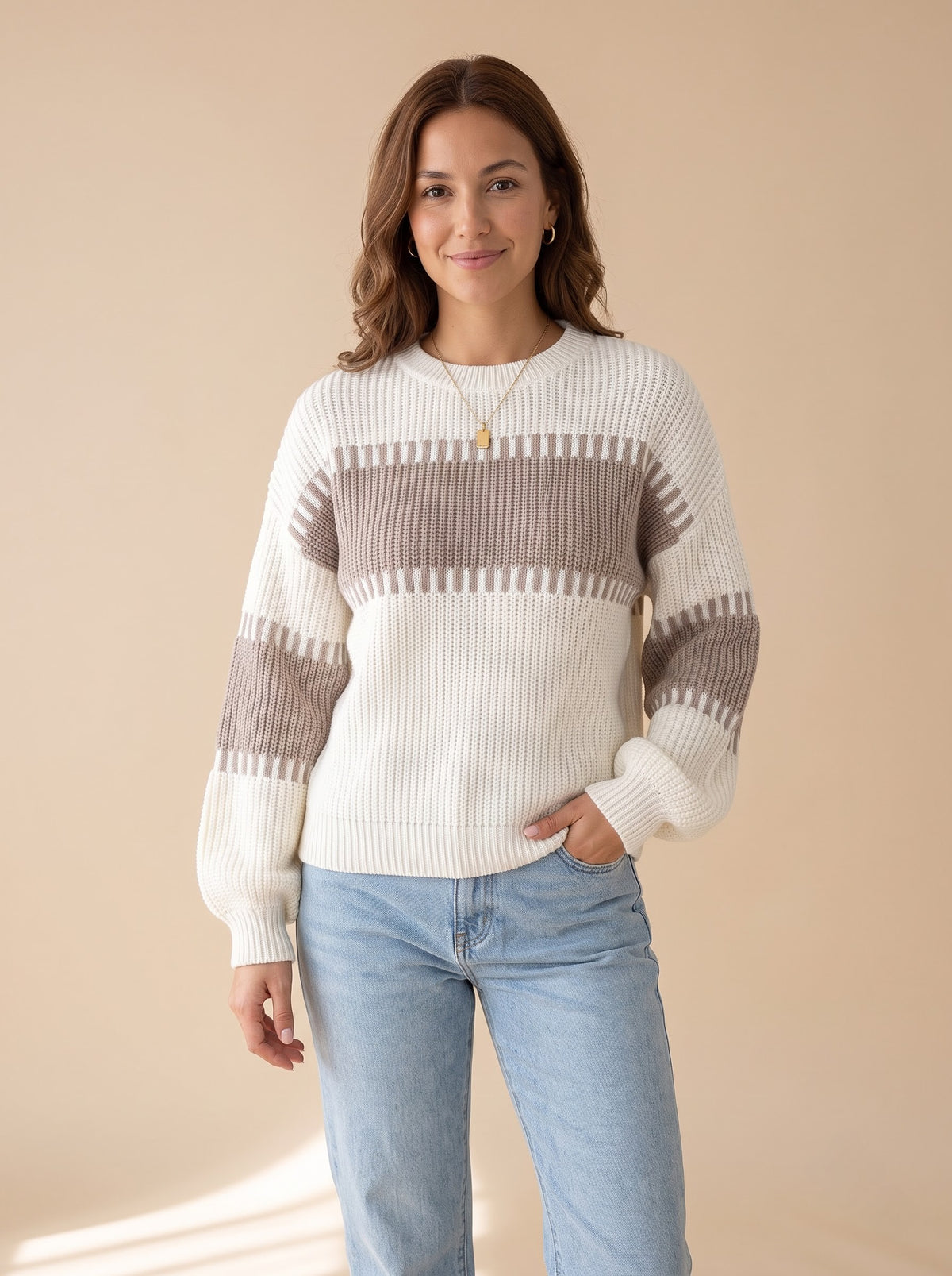 Latte Days relaxed rib knit sweater in cream with taupe color-block bands, front view with light-wash jeans, studio photo