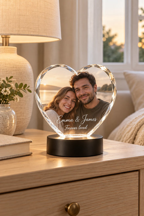 Heart-shaped crystal photo keepsake on a lit LED base, engraved with a couple's photo and names