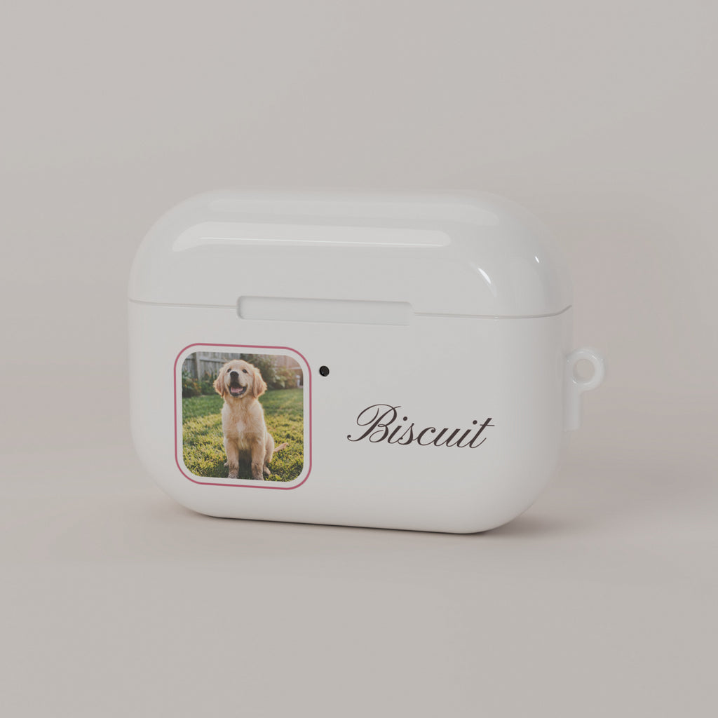 Front of a cream custom AirPods case: dog photo in a rounded rose frame next to the status light, with the name Biscuit in script
