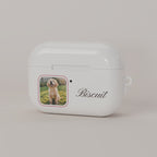 Front of a cream custom AirPods case: dog photo in a rounded rose frame next to the status light, with the name Biscuit in script