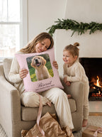 Mom and daughter hugging a personalized pet pillow by the fireplace at Christmas