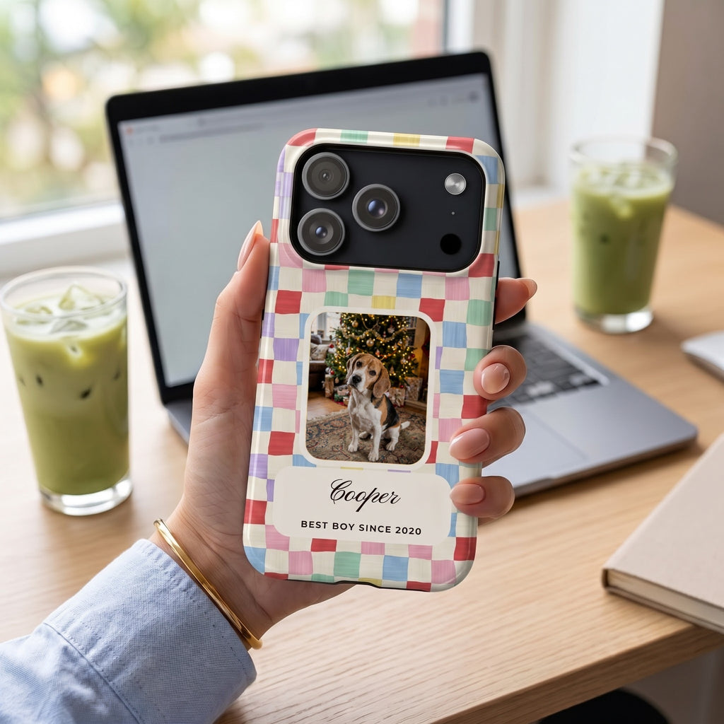 Candy checker phone case with a beagle photo window, held at a desk with iced matcha lattes