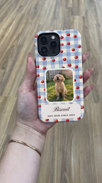 Blue gingham with red apples full-wrap case with a puppy photo window, held in hand