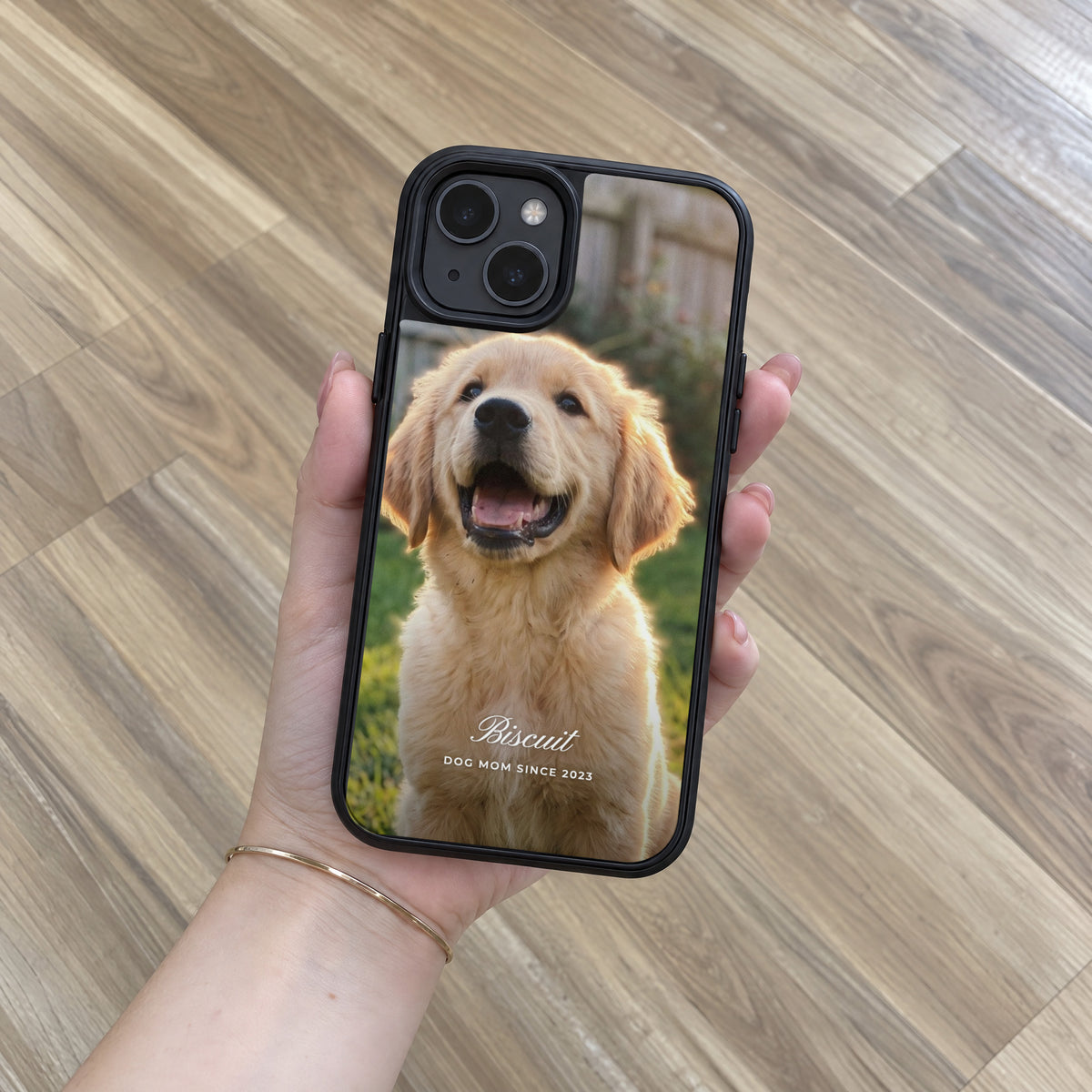 Black HoloFrame case with a full-back puppy photo print, held in hand