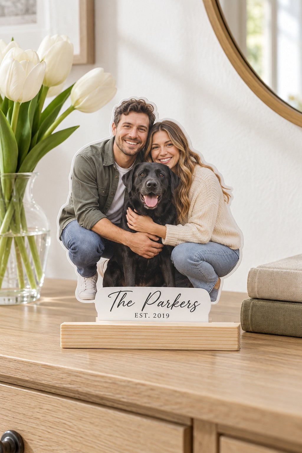 Frosted acrylic photo plaque cut around a couple hugging their black lab, The Parkers Est. 2019 on a white tab in a pine base
