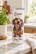 White 20 oz skinny stainless steel tumbler printed with a dog photo, name and short line, on a kitchen counter