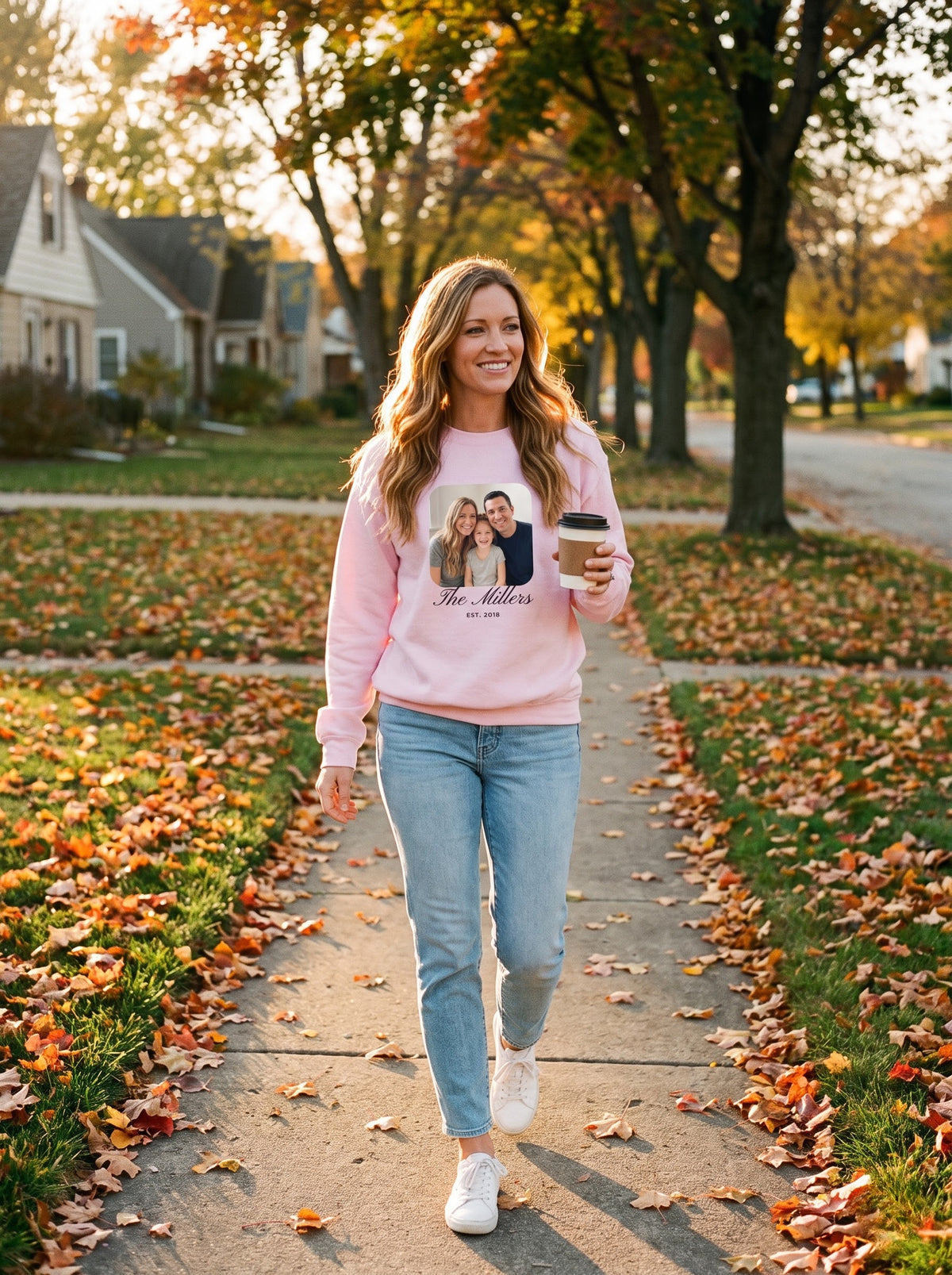 Woman walking on an autumn sidewalk in a light pink personalized photo crewneck sweatshirt