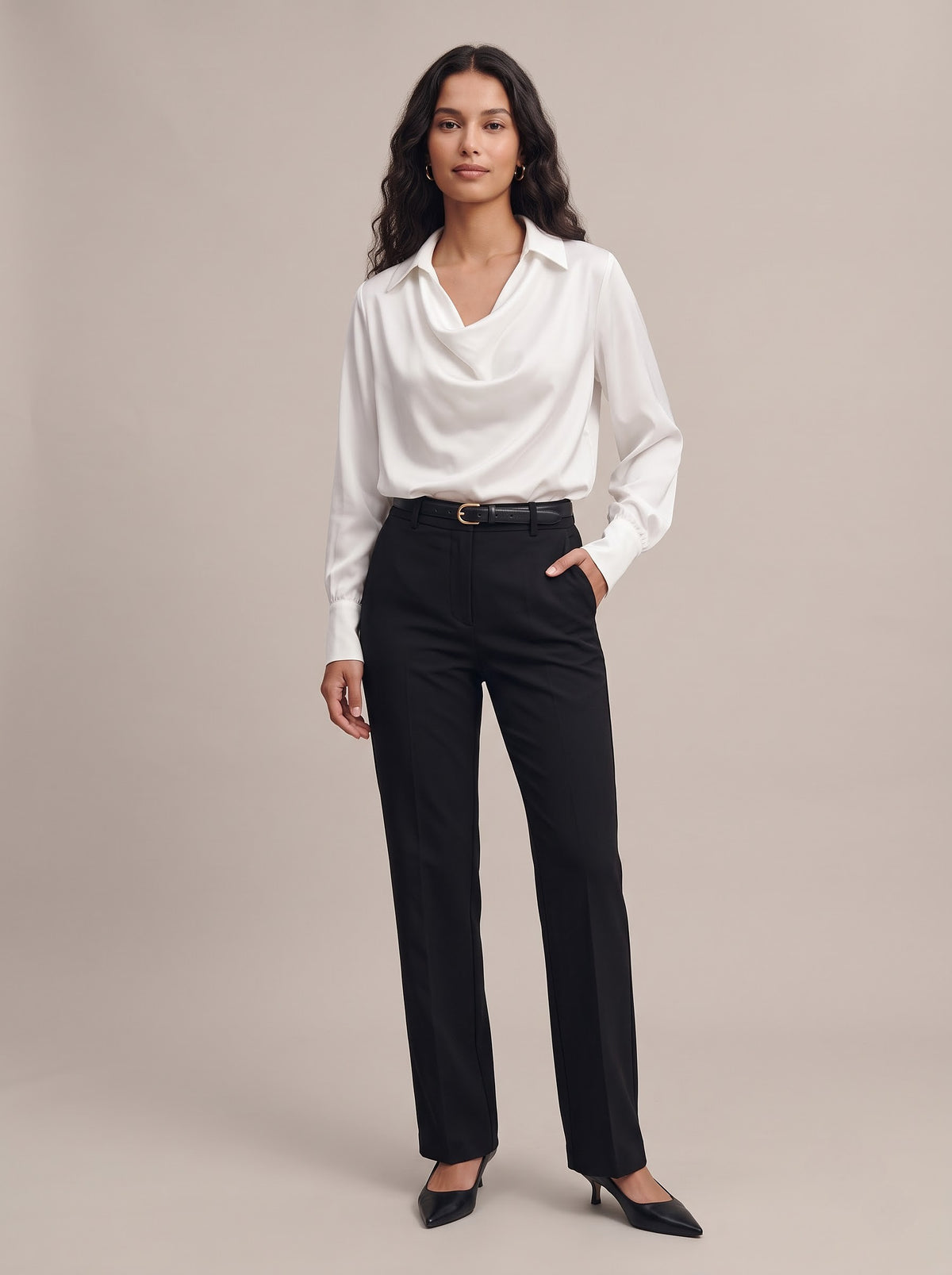 Quiet Luxe cowl neck satin blouse in white, studio view tucked into black tailored trousers